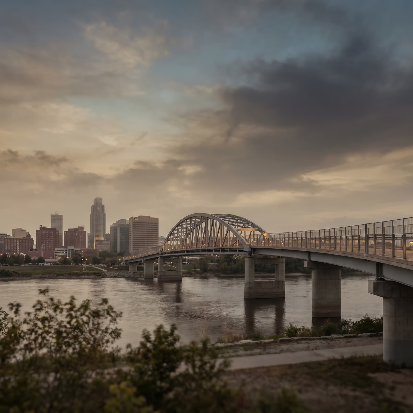 Omaha, NE — Bob Kerrey Pedestrian Bridge curving over the Missouri River at dusk